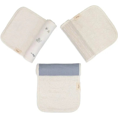 Three baby burp cloths from the Crane Bedding Cove set, featuring ocean-themed designs and textures in soft colors.