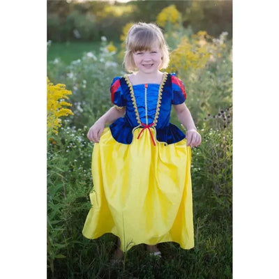 Deluxe Disney Snow White dress worn by a child in a field, featuring a blue bodice, red accents, and a yellow skirt.