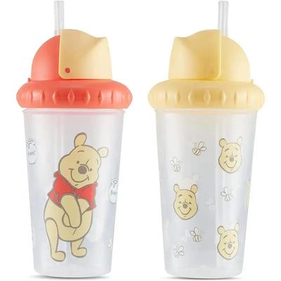 Two sipper cups featuring Winnie the Pooh, one with a red lid and the other with a yellow lid, both decorated with bees.
