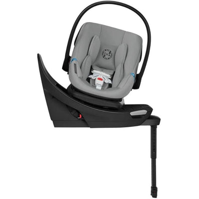 Cybex Aton G2 swivel infant car seat in stone grey with load leg base and safety harness visible.