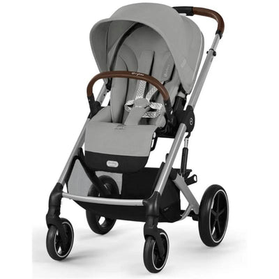 Cybex Balios S Lux stroller in Stone Grey, featuring a large canopy, cushioned seat, and brown leatherette handle.