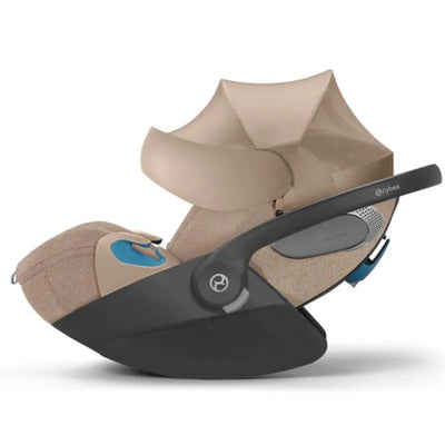 Cybex Cloud T Sensorsafe Infant Car Seat in Cozy Beige with a safety handle and protective canopy.