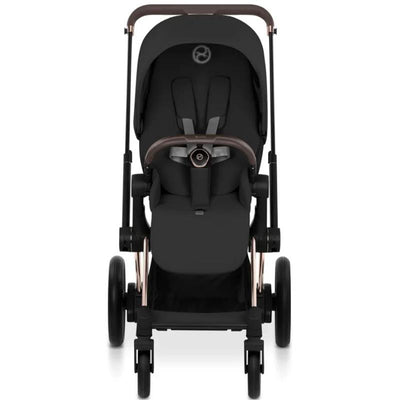 Cybex E-Priam stroller with a rose gold frame and sepia black lux seat, featuring a modern design and safety harness.