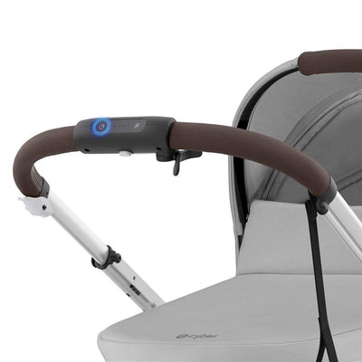 Cybex Egazelle S stroller featuring a silver frame, stone grey seat, and a brown handlebar with control buttons.