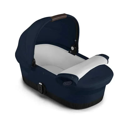 Cybex Gazelle S Cot in Ocean Blue, featuring a navy exterior, white interior, and a cushioned handle.