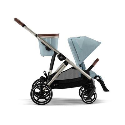 Cybex Gazelle S 2 stroller in taupe frame with stormy blue seat and canopy, featuring a storage basket and adjustable handle.