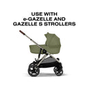 Cybex Gazelle S Cot in Moss Green, designed for use with e-Gazelle and Gazelle S strollers, shown at an angle.