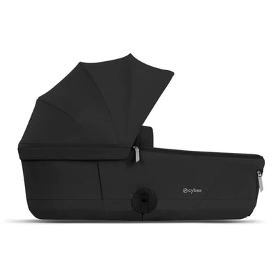Cybex Mios/Coya Fold Lux Carry Cot in Sepia Black with a sunshade and zipper detail for easy portability.