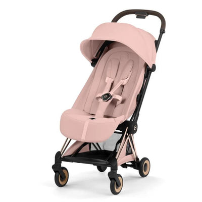 Cybex Platinum Coya Stroller with a rose gold frame and peach pink lux seat, featuring a reclining backrest and safety harness.