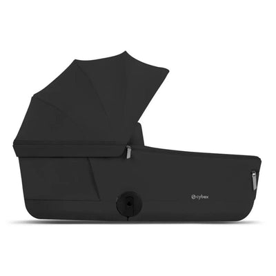 Cybex Priam Fold Lux Carry Cot in Sepia Black with a folding canopy and zippered storage compartments.