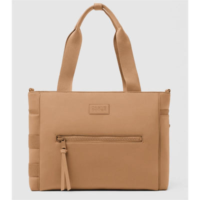 Camel-colored Dagne Dover Wade Diaper Tote with two handles, a front zip pocket, and textured sides.