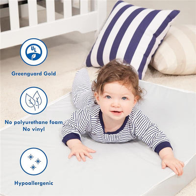 Toddler in striped pajamas on a gray mattress, with features highlighting the Million Dollar Baby crib mattress.