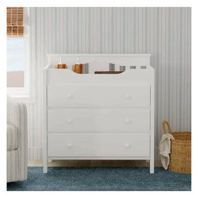 White DaVinci Jayden 3-Drawer Changer Dresser with rounded edges and three spacious drawers, styled in a nursery setting.