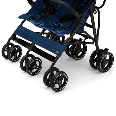 Classic side-by-side double stroller in navy camo with four wheels, adjustable seats, and a stylish canopy.