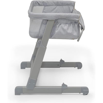 Delta Whisper Bedside Bassinet in grey stripes features a fabric side and a sturdy metal frame.