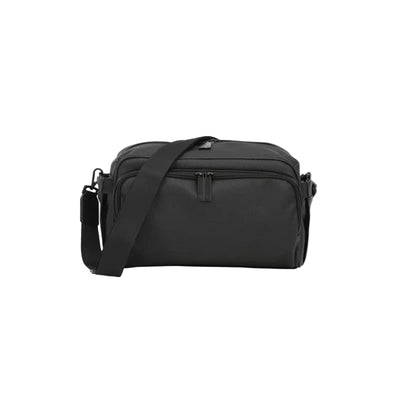 Black DFY - R1 Diaper Bag with shoulder strap, featuring multiple compartments and a sleek, modern design.