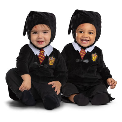 Two toddlers wear official Harry Potter costumes, featuring black robes with Gryffindor emblems and distinctive hats.