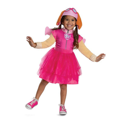 Toddler wearing a bright pink Paw Patrol Skye tutu costume with dog ears and a hat, smiling and posing playfully.