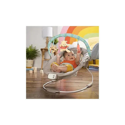 Disney Baby Winnie The Pooh Bouncer featuring a smiling baby, dangling toys, and a colorful play arch.