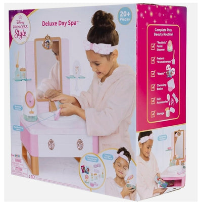 Disney Princess Deluxe Day Spa Style Set, featuring a girl in a robe using a toy vanity with accessories for pretend spa play.
