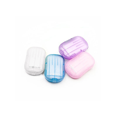 Colorful soap sheets in various pastel shades, including pink, blue, purple, and white, packaged for travel convenience.