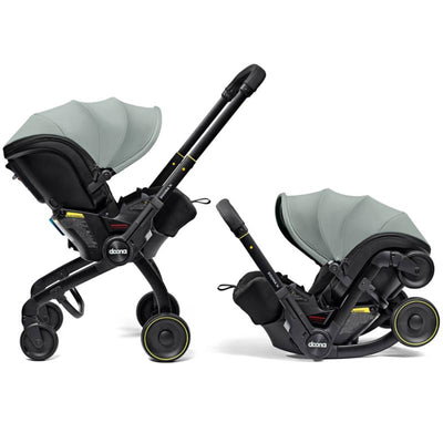Doona X Infant Car Seat & Latch Base in Dusty Sage, featuring an adjustable canopy, harness, and wheels for easy mobility.