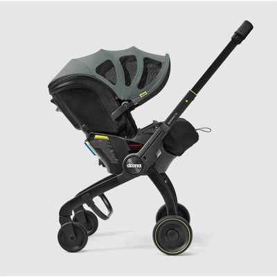Doona X Summer Canopy in slate green, featuring a car seat stroller combination with a large canopy and safety features.
