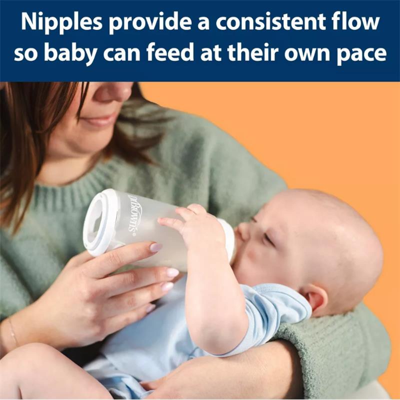 Silicone baby bottle held by a woman feeding a baby, emphasizing nipple design for a consistent flow.