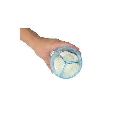 Hand holding a Dr. Brown Formula Caddy Blue, a divided container for storing powdered formula.