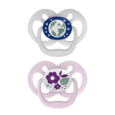 Two Dr. Brown’s Advantage Pacifiers, Stage 2, one featuring a globe design in blue and white, the other with a floral pattern in pink and white.