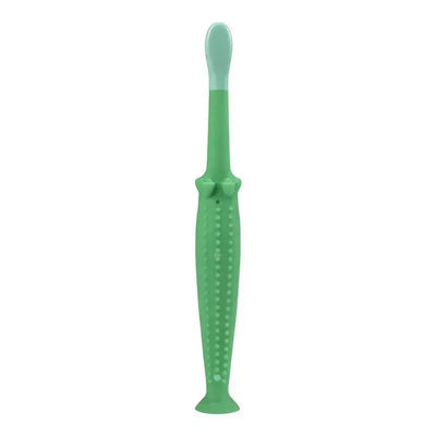 Green crocodile-shaped toddler toothbrush with a soft bristle top and textured handle for easy grip.