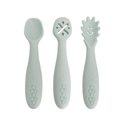 Scoop and Mash utensils in soft seafoam green, featuring a scoop, a twist, and a textured handle, ideal for feeding toddlers.