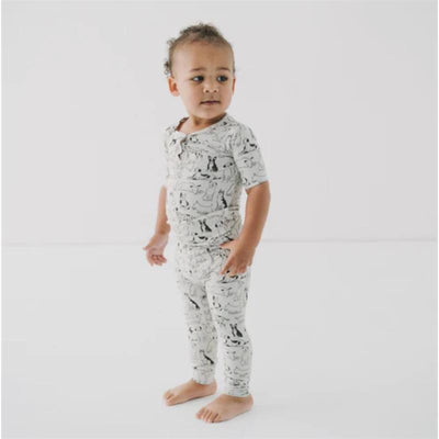 Toddler wearing Ellie Sue Good Dog Pajama Set, featuring a playful dog print on a light background.