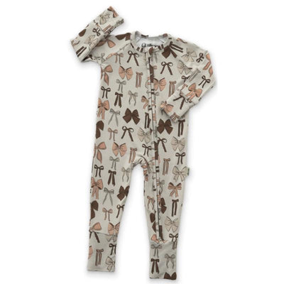 Zipper romper for babies featuring a pattern of variously colored bows on a light background.