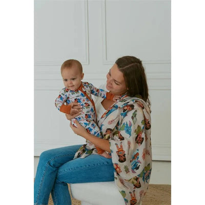 Mom holds a baby wearing a colorful Ellie Sue Baby Ohana Zipper Romper, both smiling against a simple background.