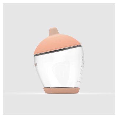 Classic bottle nipple in fair color, featuring a transparent body with measurement markings and a soft peach-colored cap.