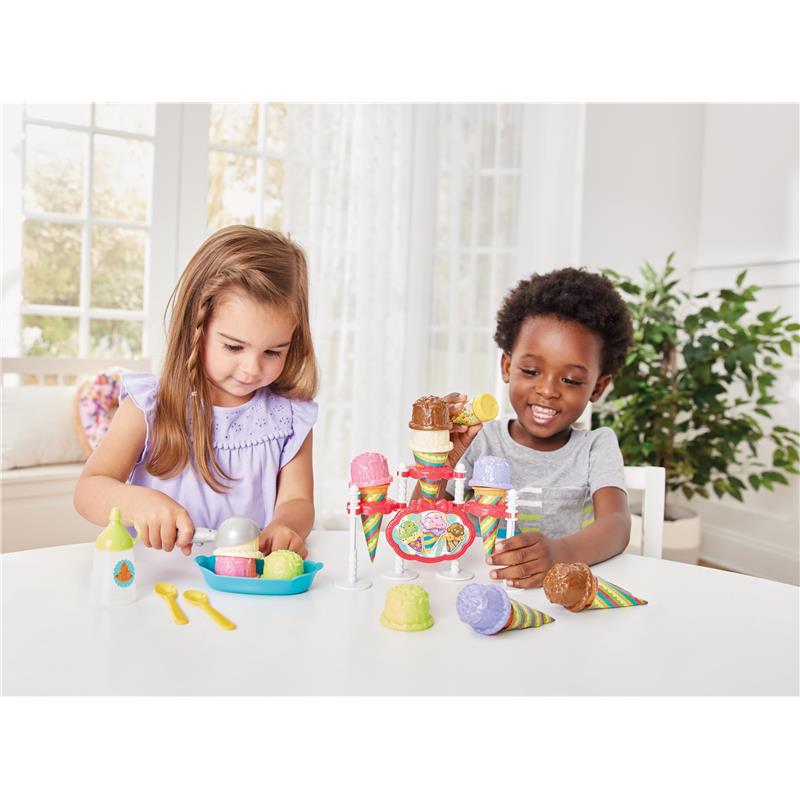 Children playing with the Epoch Just Imagine Ice Cream Party Playset, scooping colorful fake ice cream into cones.