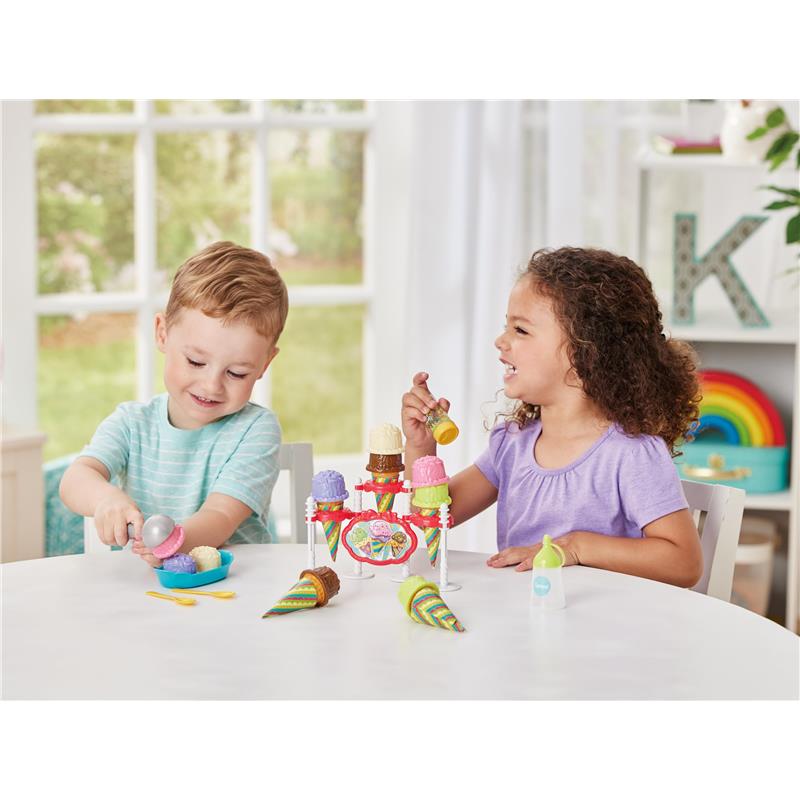 Children play with the Epoch Just Imagine Ice Cream Party Playset, serving colorful ice cream scoops from a vibrant stand.