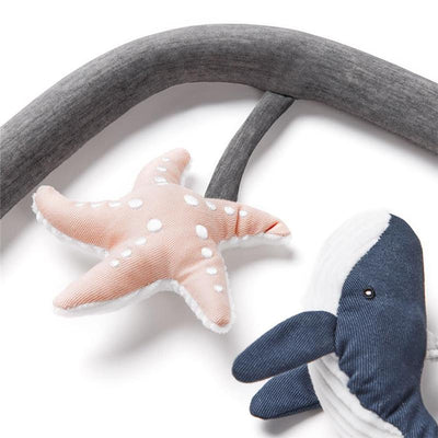 Ergobaby Evolve 3-in-1 bouncer toy bar accessory featuring a pink starfish and navy whale plush toys.