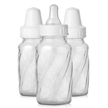 Classic glass baby bottles from Evenflo, 4 oz size, with decorative twisting design and white nipples.