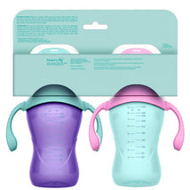 Two Evenflo 9 oz baby sippy cups in pink and purple, featuring measurement markings and handles for easy gripping.