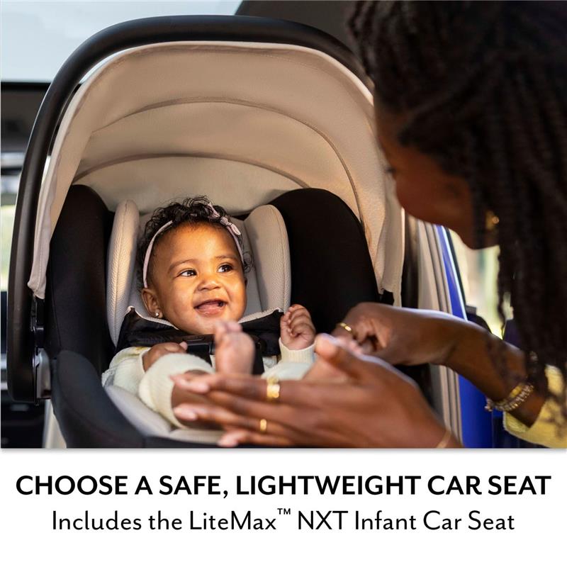 A happy infant in a LiteMax NXT car seat is smiles at a caregiver gesturing playfully, promoting safety and comfort.