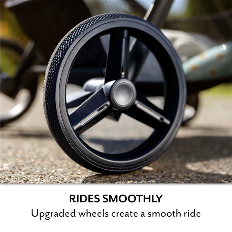 Black wheel of the Evenflo Pivot NXT Travel System, showcasing its upgraded design for a smooth ride on various terrains.