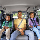 Three children seated in Evenflo Revolve360 Slim 2-in-1 Rotating Convertible Car Seats in the back of a vehicle.