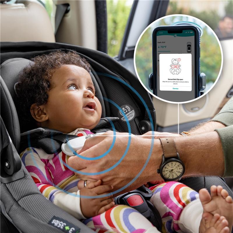 Infant in Evenflo Shyft Dualride car seat, secured and smiling, with a smartphone displaying safety information.