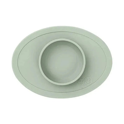 Sage-colored ezpz Tiny Bowl with a central round bowl, designed for easy meal serving for children.