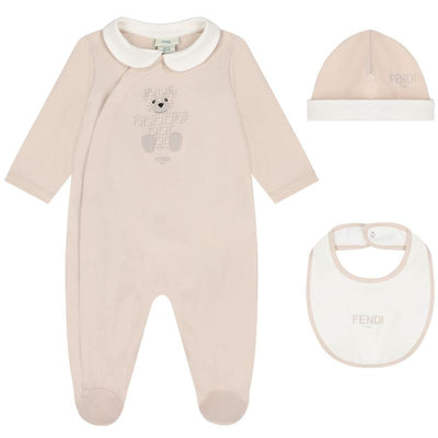 Fendi baby footie, bib, and hat set featuring a bear graphic and logo, in soft beige with a white collar.