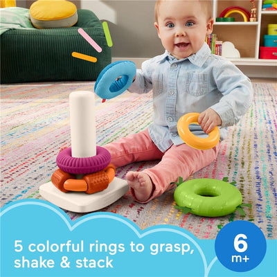 Baby enjoying the Fisher Price Sensory Rock-a-Stack toy, featuring 5 colorful rings for grasping, shaking, and stacking.