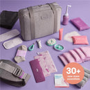 Gray travel bag with 30+ essentials for new moms, including skin care, nursing pads, and hygiene items, arranged on a purple background.