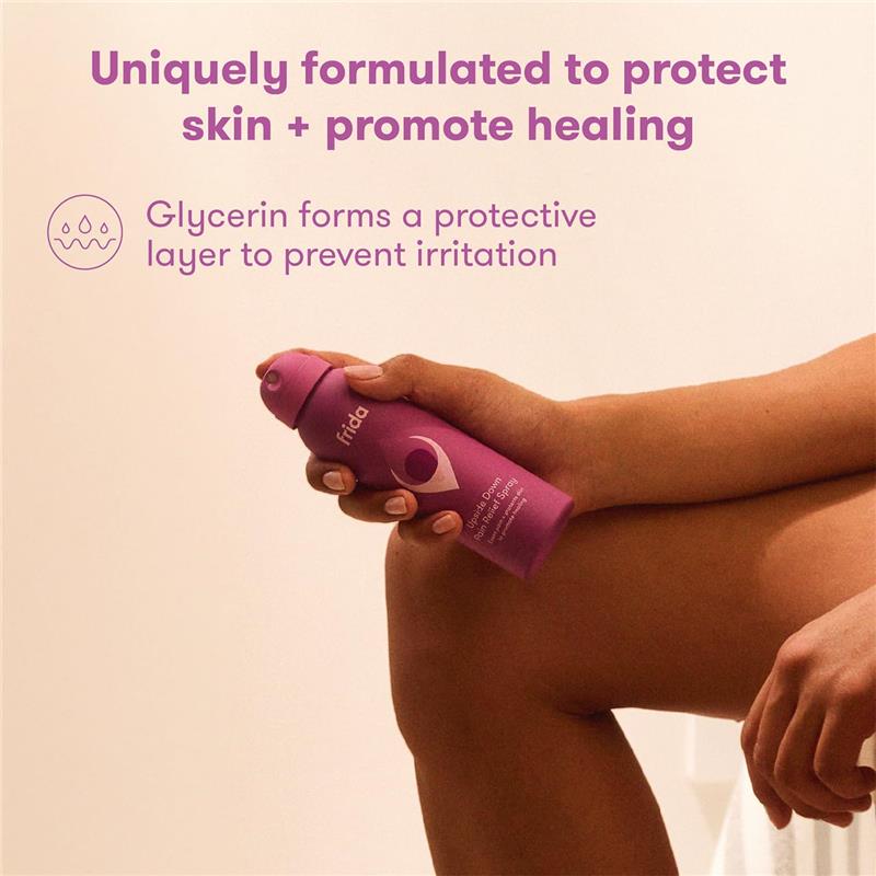 Frida Mom Anesthetic Spray in a purple bottle, designed for postpartum skin protection and healing, held by a hand.